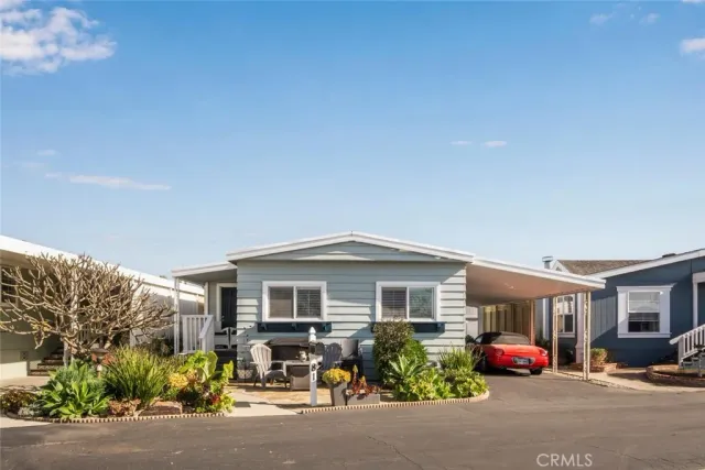 a view of a house with sitting area and garden