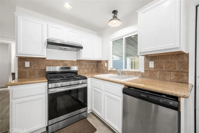 a kitchen with a stove and a sink