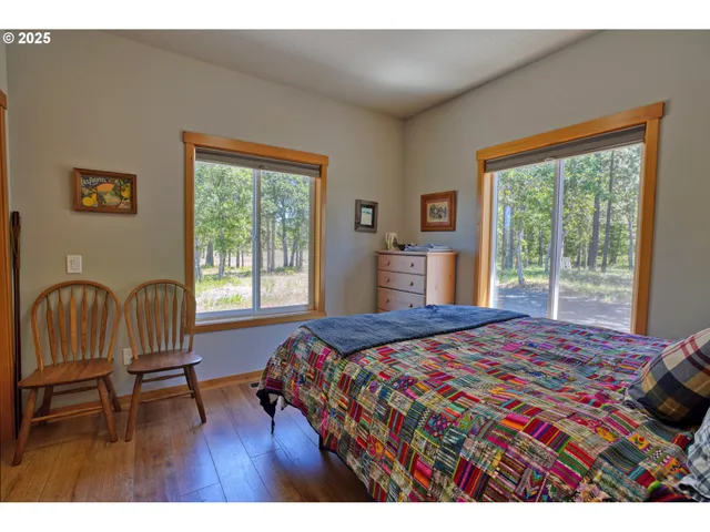a bedroom with a bed and a large window