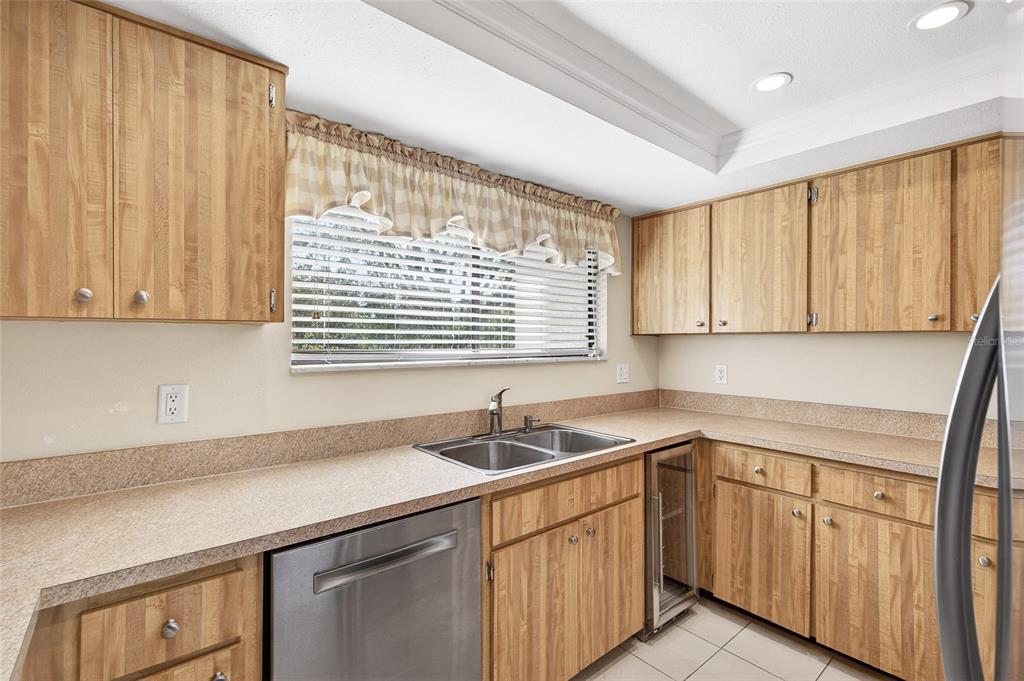 214 Caryl Way Oldsmar, FL 34677 - Photo 21 of 44 a kitchen with stainless steel appliances granite countertop white cabinets sink and window