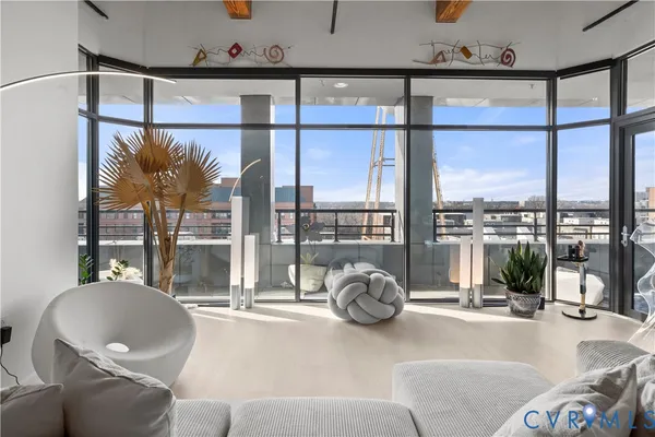 a living room filled with furniture and a large window