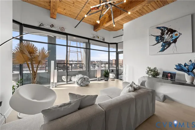 a living room with furniture and a floor to ceiling window