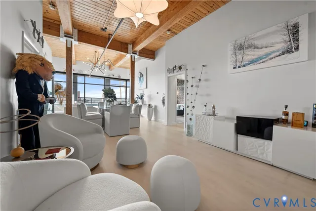 a living room with furniture and a chandelier