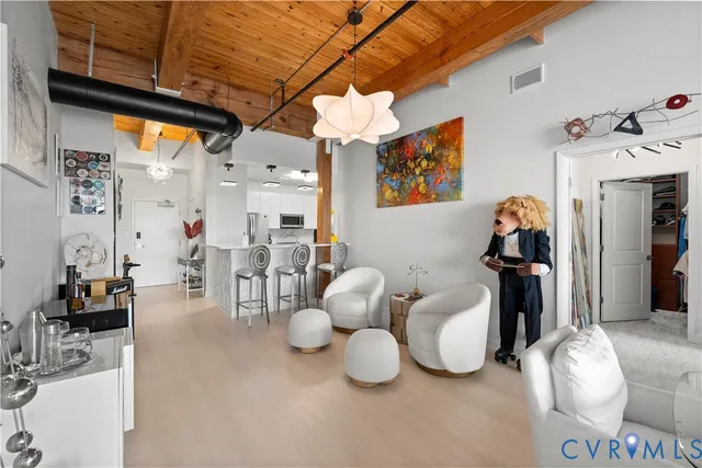 a living room with furniture and a floor to ceiling window