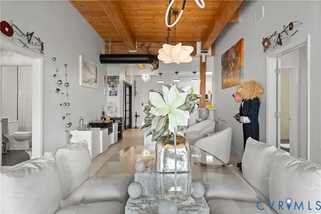a view of a hallway with dining area and chandelier