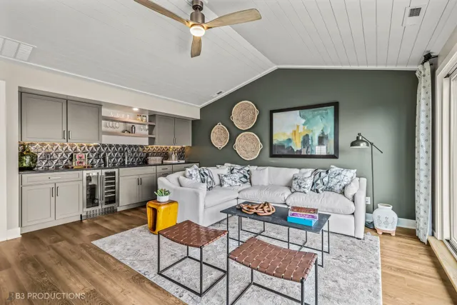 a living room with furniture and kitchen view