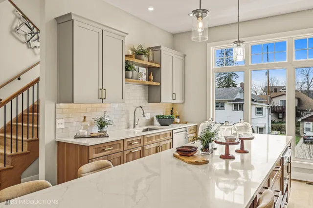 a kitchen with sink refrigerator and dining table