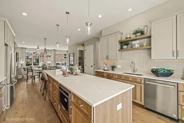 a kitchen with a sink a stove and chairs
