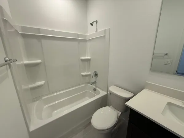 a bathroom with a toilet a sink and bathtub