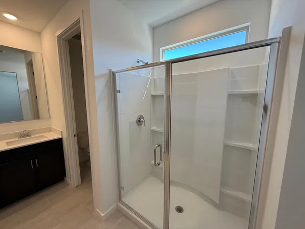 a bathroom with a shower and a sink