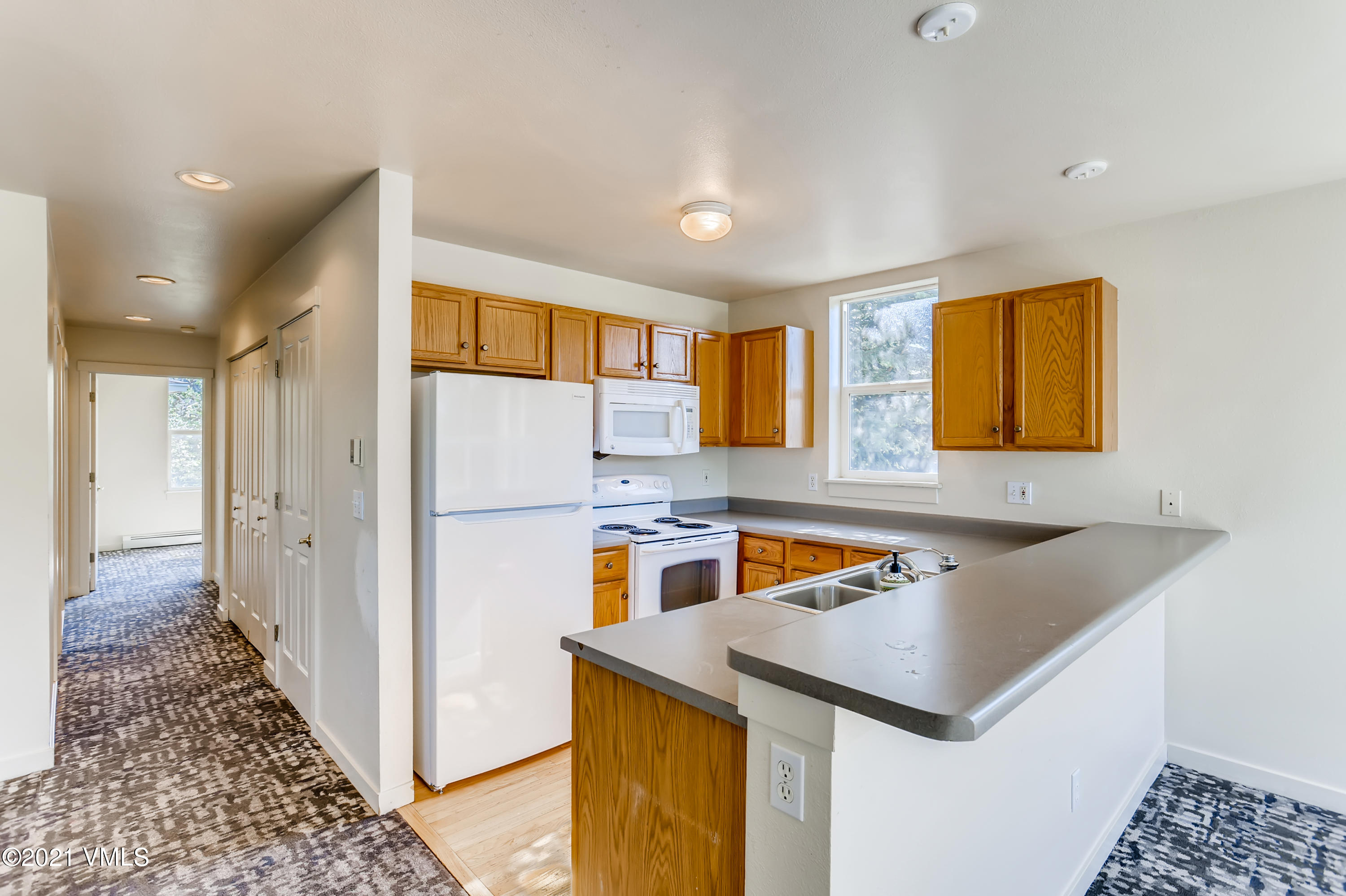 530 Founders Avenue, Unit A201 Eagle, CO 81631 - Photo 11 of 27 a kitchen with a sink a counter top space and cabinets