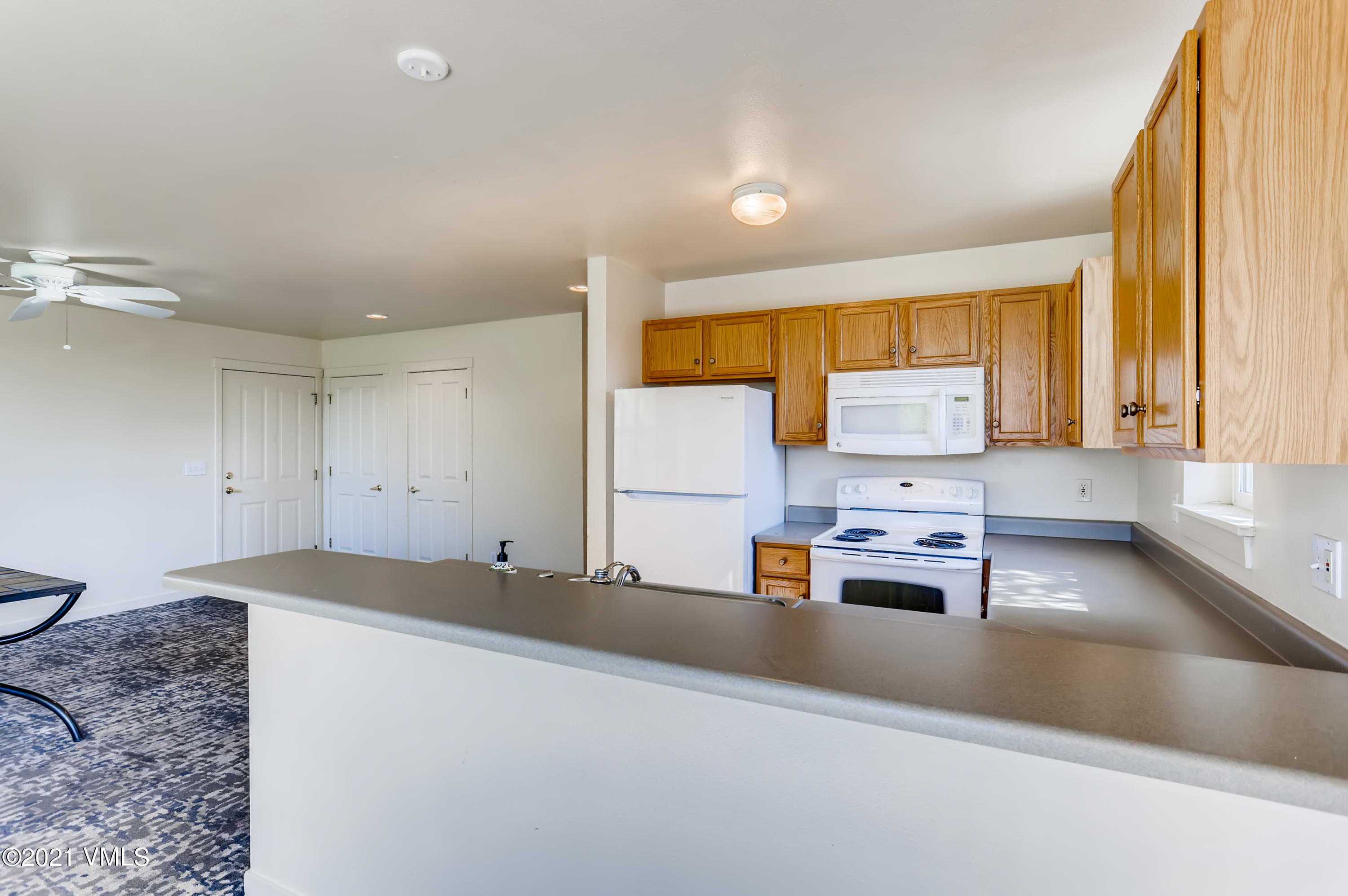 530 Founders Avenue, Unit A201 Eagle, CO 81631 - Photo 12 of 27 a living room with stainless steel appliances kitchen island granite countertop furniture and a large window