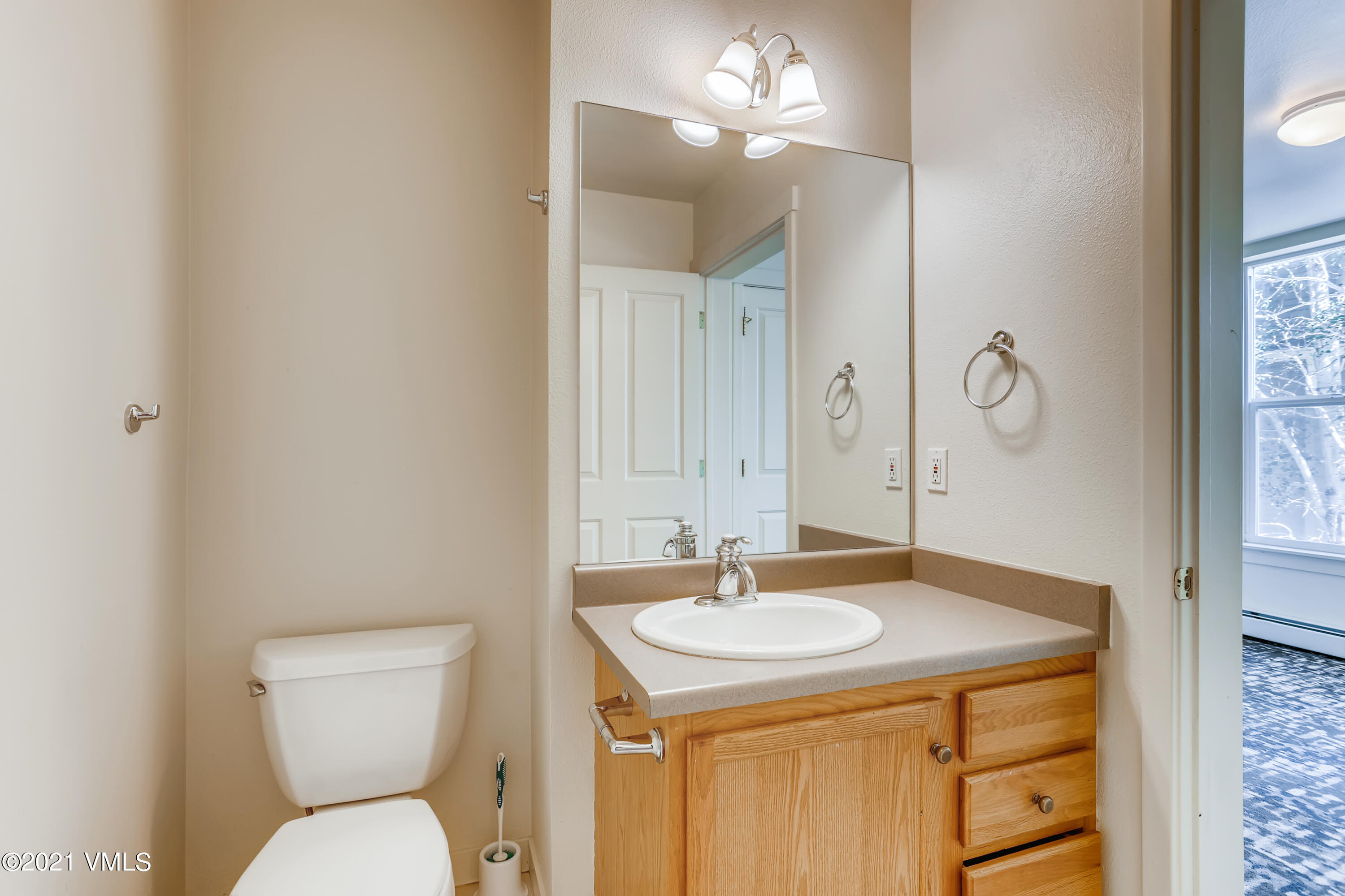530 Founders Avenue, Unit A201 Eagle, CO 81631 - Photo 20 of 27 a bathroom with a sink a toilet and a mirror