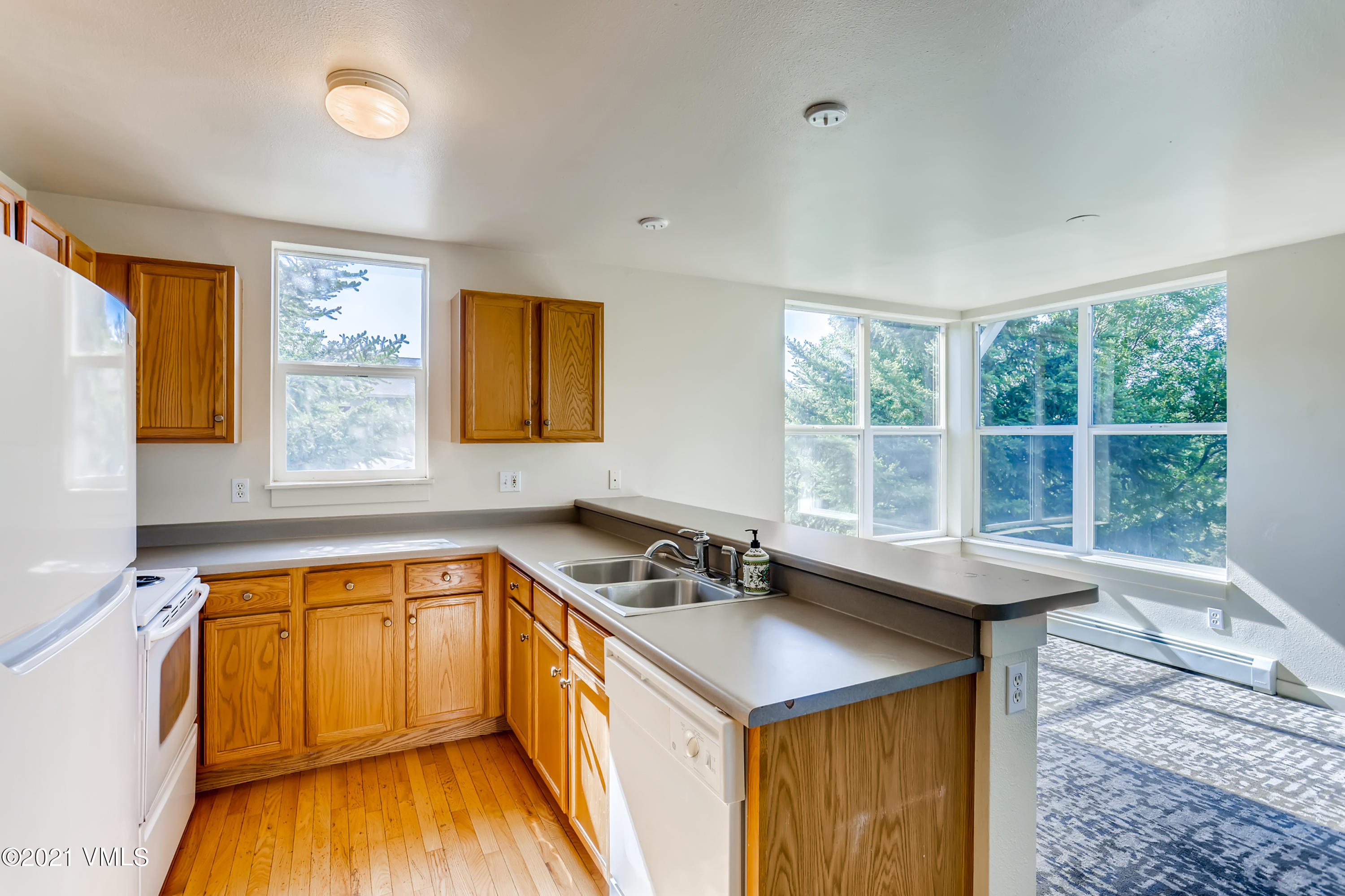 530 Founders Avenue, Unit A201 Eagle, CO 81631 - Photo 6 of 27 a kitchen that has a sink and a wooden floor