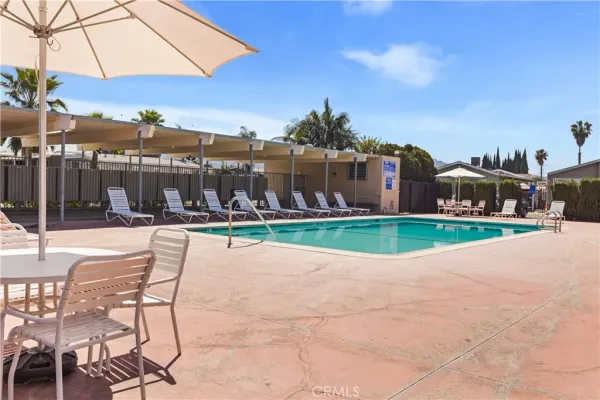 a view of a house with a swimming pool and a yard