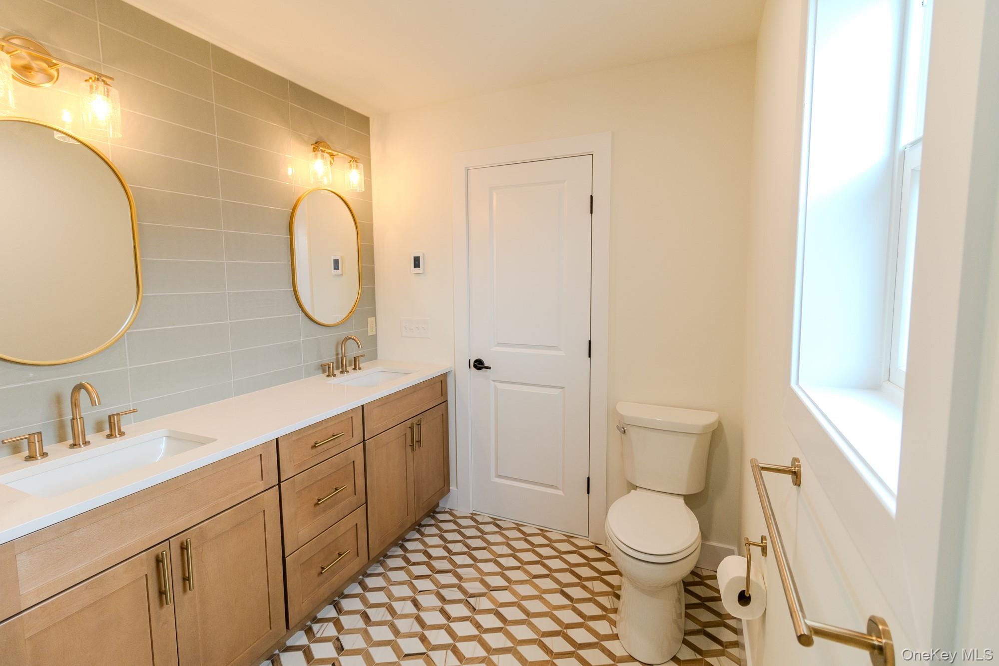 1 Ridge Avenue Port Jervis, NY 12771 - Photo 12 of 31 a spacious bathroom with a double vanity sink toilet and a mirror