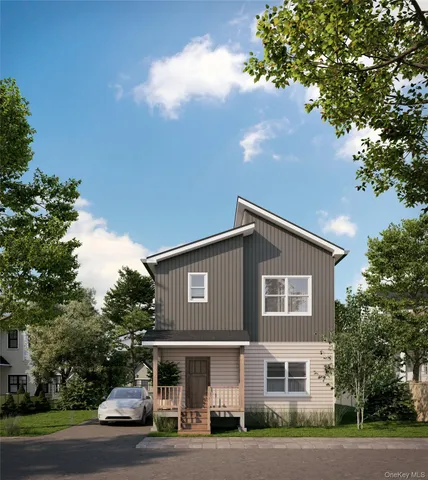 a front view of a house with a garden and parking