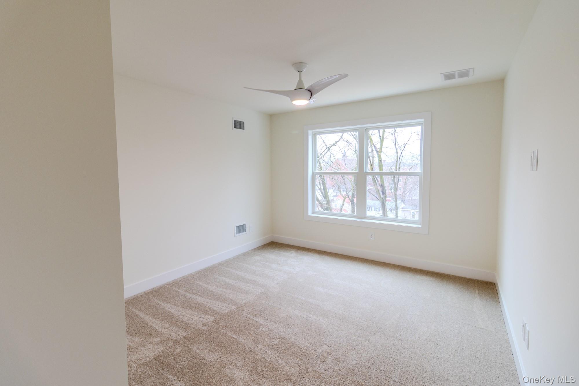 1 Ridge Avenue Port Jervis, NY 12771 - Photo 10 of 31 an empty room with windows and chandelier fan