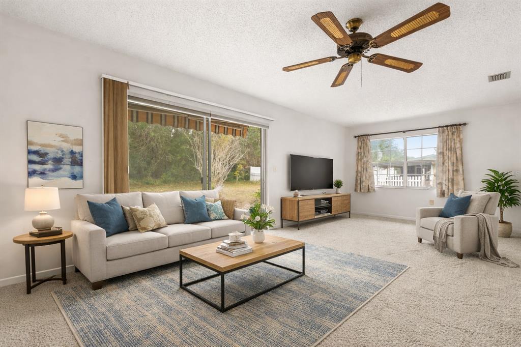 15218 Southwest 43rd Terrace Road Ocala, FL 34473 - Photo 11 of 30 a living room with furniture and a flat screen tv