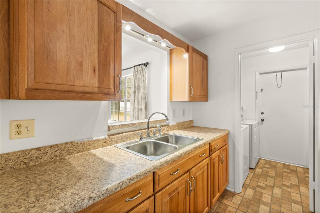 15218 Southwest 43rd Terrace Road Ocala, FL 34473 - Photo 14 of 30 a kitchen with a sink stove and refrigerator