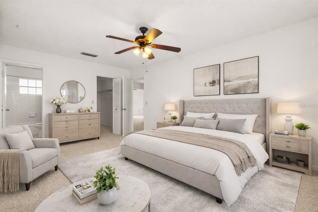 15218 Southwest 43rd Terrace Road Ocala, FL 34473 - Photo 19 of 30 a bedroom with a bed mirror and couch