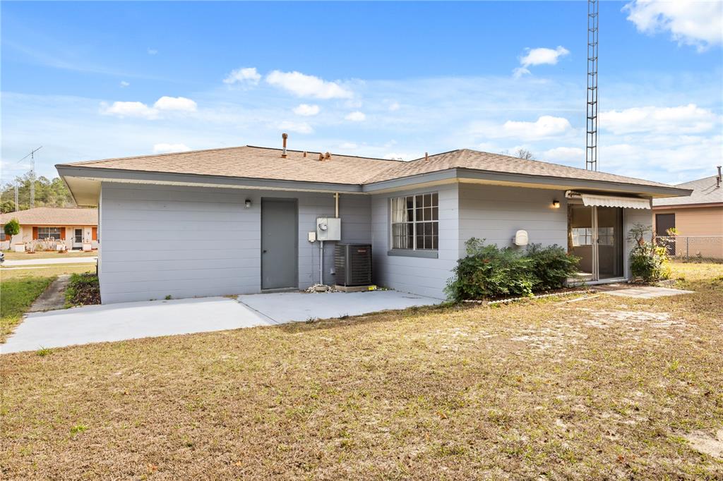 15218 Southwest 43rd Terrace Road Ocala, FL 34473 - Photo 29 of 30 a front view of a house with a yard and garage