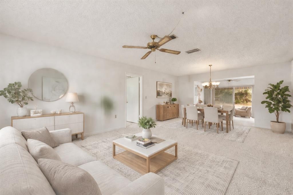 15218 Southwest 43rd Terrace Road Ocala, FL 34473 - Photo 5 of 30 a living room with furniture a chandelier and a dining table