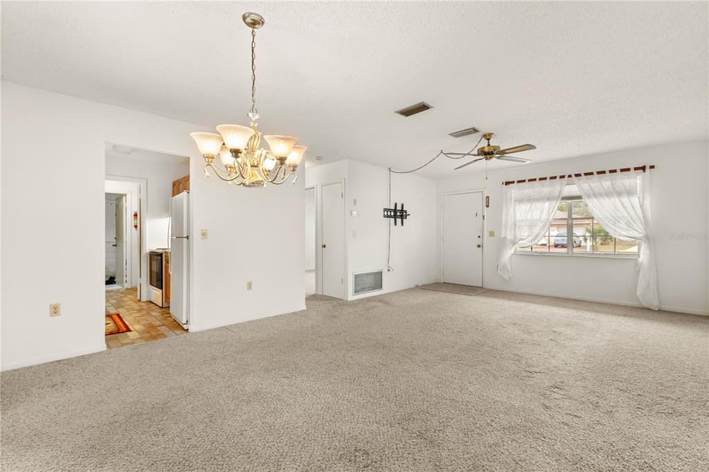 15218 Southwest 43rd Terrace Road Ocala, FL 34473 - Photo 8 of 30 a very nice looking room with window and chandelier