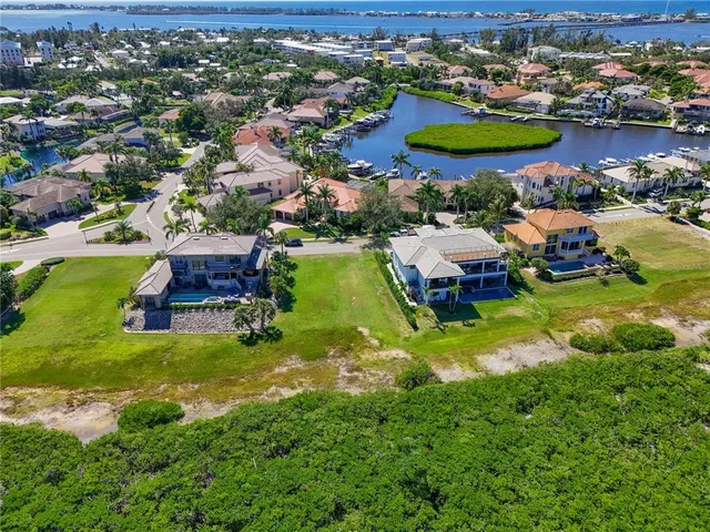 an aerial view of residential houses with outdoor space and swimming pool
