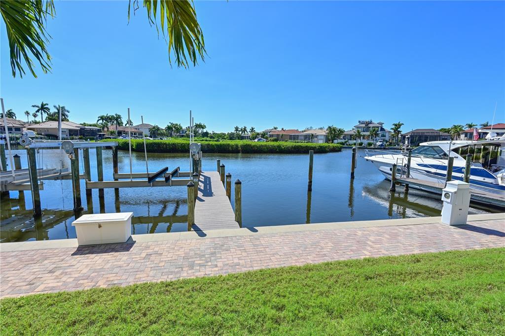 12405 Baypointe Terrace Cortez, FL 34215 - Photo 5 of 31 a view of a lake with a table and chairs