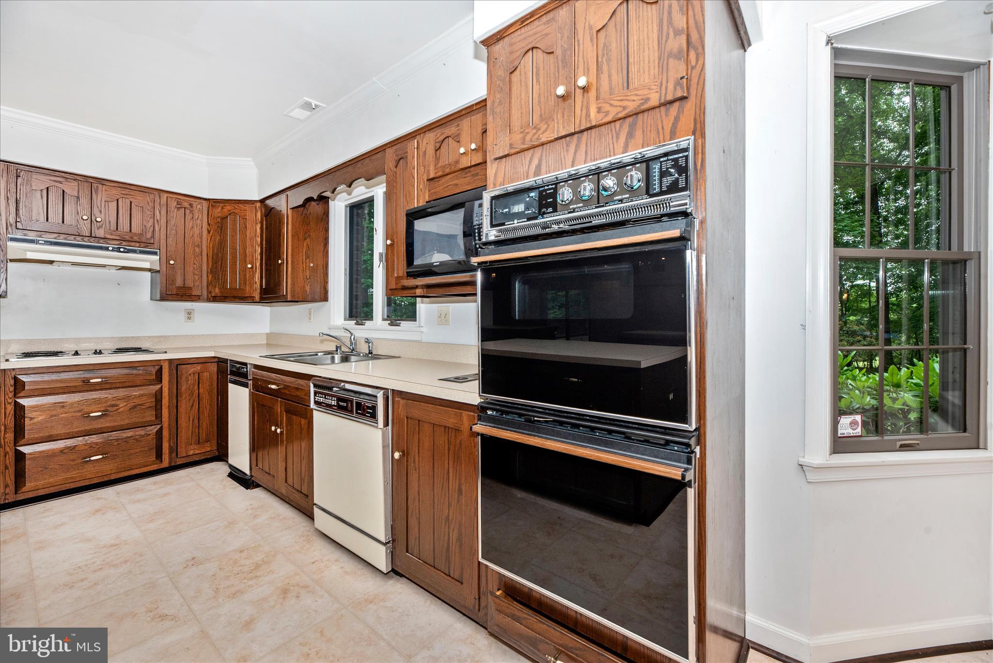 2221 Gold Mine Road Brookeville, MD 20833 - Photo 17 of 60 a kitchen with a stove and a microwave