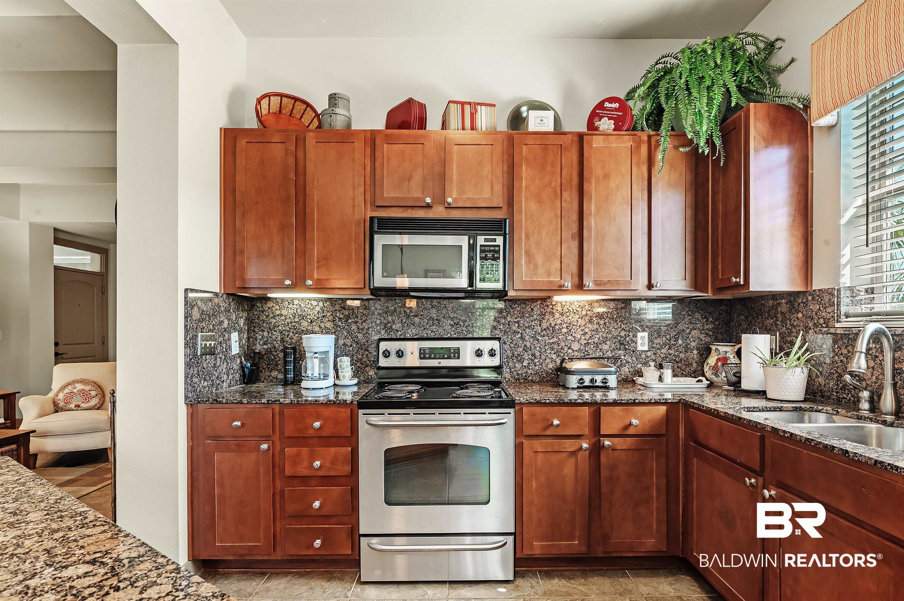 1430 Regency Road, Unit A301 Gulf Shores, AL 36542 - Photo 15 of 47 Kitchen with sink, stainless steel appliances, backsplash, and dark stone counters