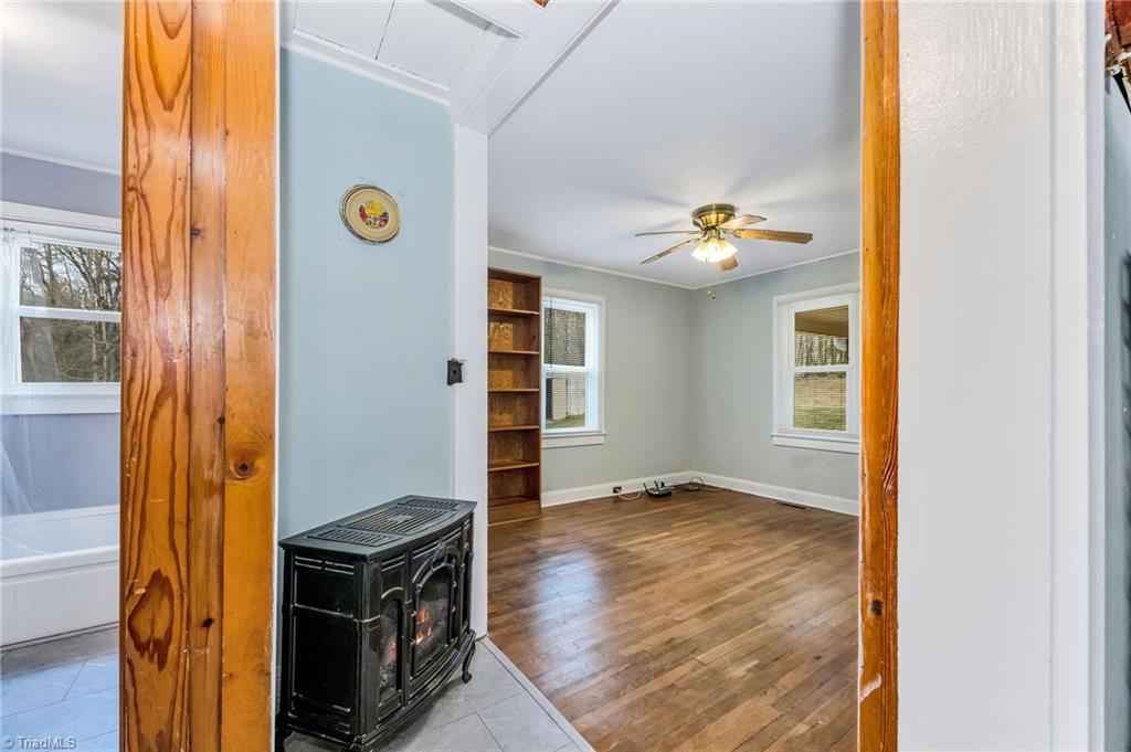 286 Pike Road Moravian Falls, NC 28654 - Photo 14 of 38 Looking from Kitchen to Den/Dining area with gas log stove in hall. First full bath to left off bedroom hallway.