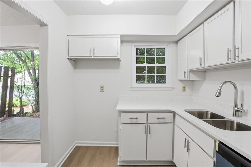 413 Promenade Court Marietta, GA 30064 - Photo 8 of 28 a kitchen with a sink cabinets and window