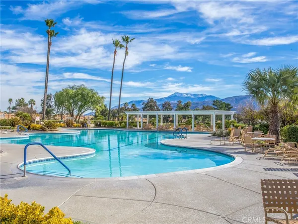 a view of swimming pool with outdoor seating