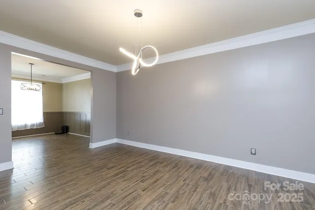 a view of a livingroom with wooden floor and a flat screen tv