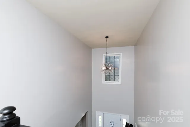 a spacious bedroom with a bed and a chandelier