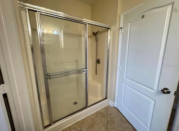 a bathroom with a glass shower door