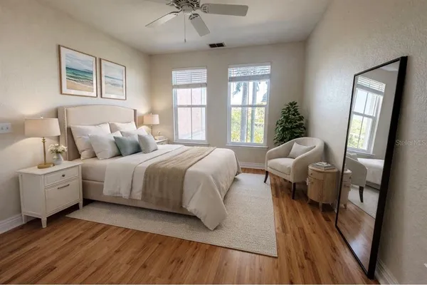 a spacious bedroom with a bed couch and a window