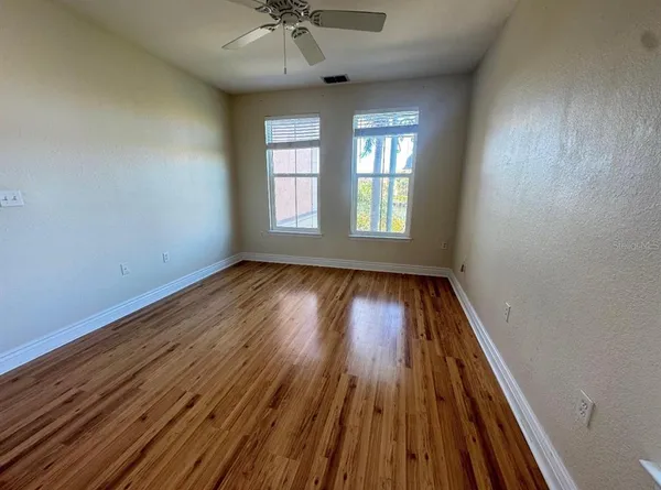 wooden floor in an empty room with a window
