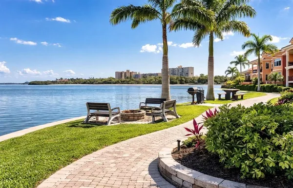a view of a lake with couches and city view