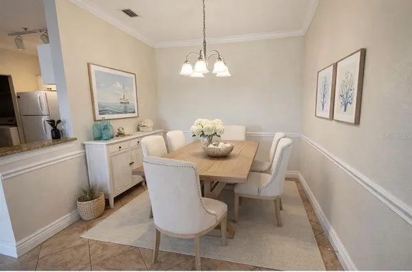 a view of a dining room with furniture and chandelier