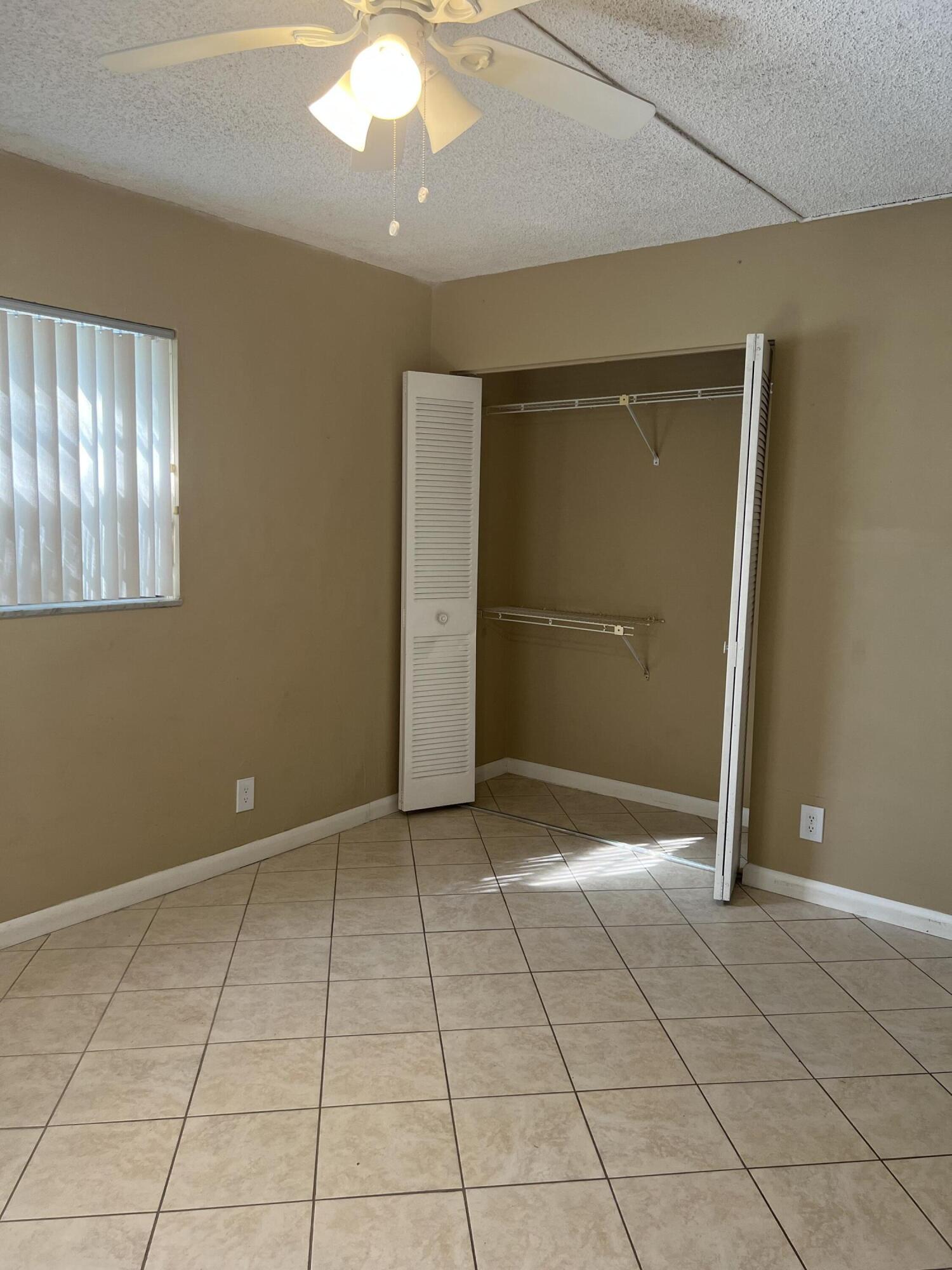 886 Flanders South Delray Beach, FL 33484 - Photo 13 of 41 a view of a livingroom with an empty space and a window