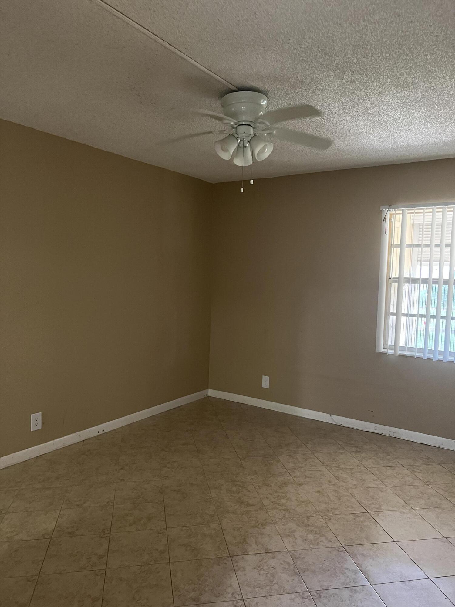 886 Flanders South Delray Beach, FL 33484 - Photo 24 of 41 en empty room with windows and ceiling fan