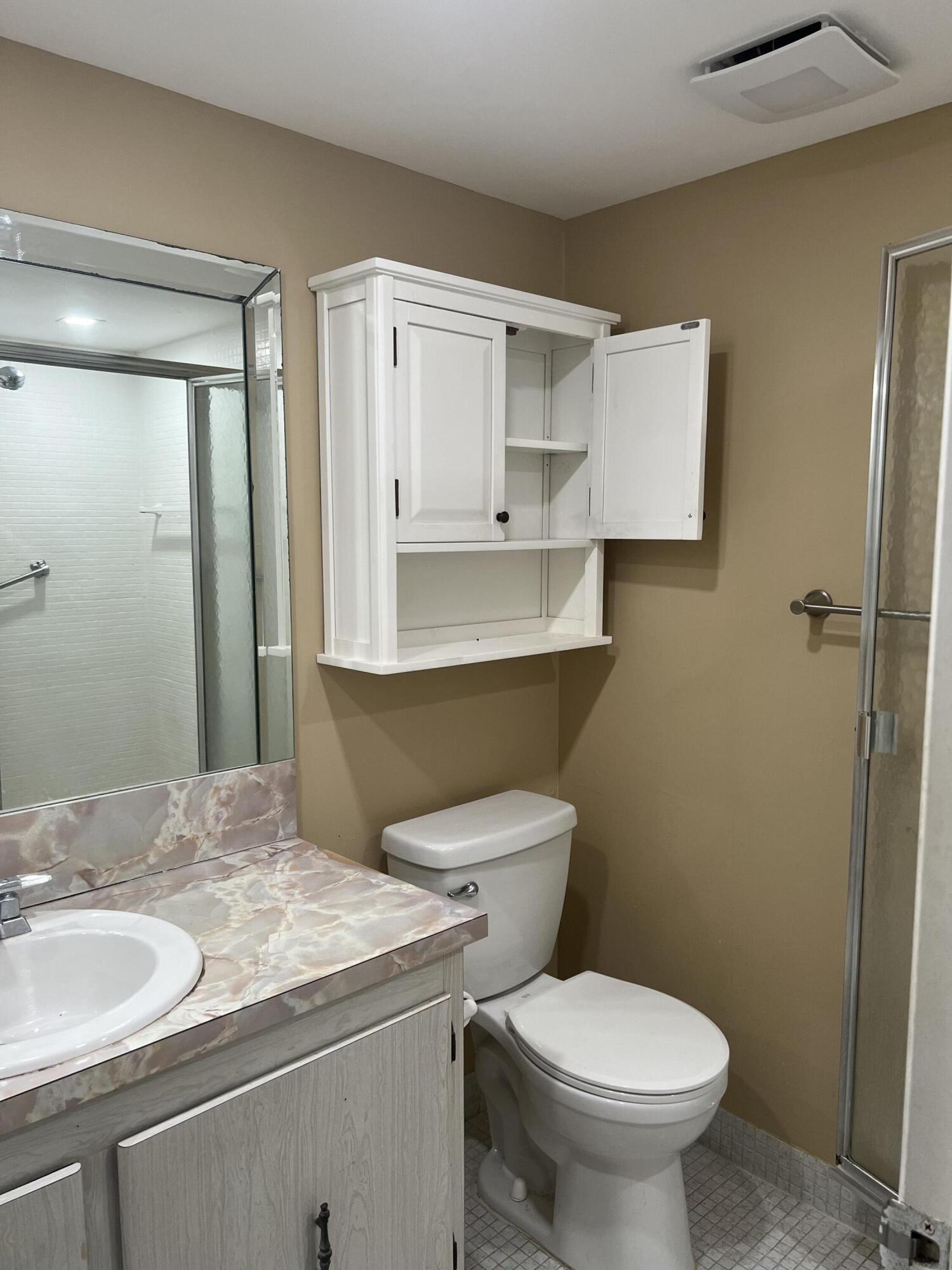 886 Flanders South Delray Beach, FL 33484 - Photo 26 of 41 a bathroom with a granite countertop toilet sink and mirror