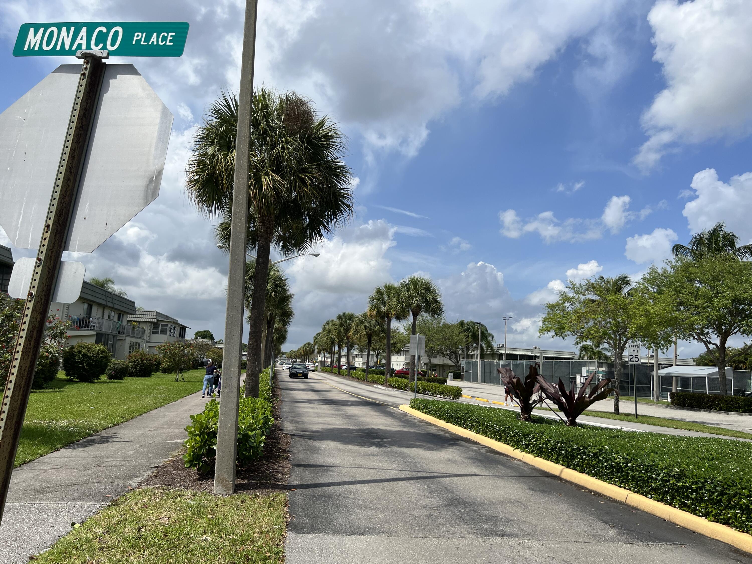 886 Flanders South Delray Beach, FL 33484 - Photo 32 of 41 a front view of a house with a yard and car parked