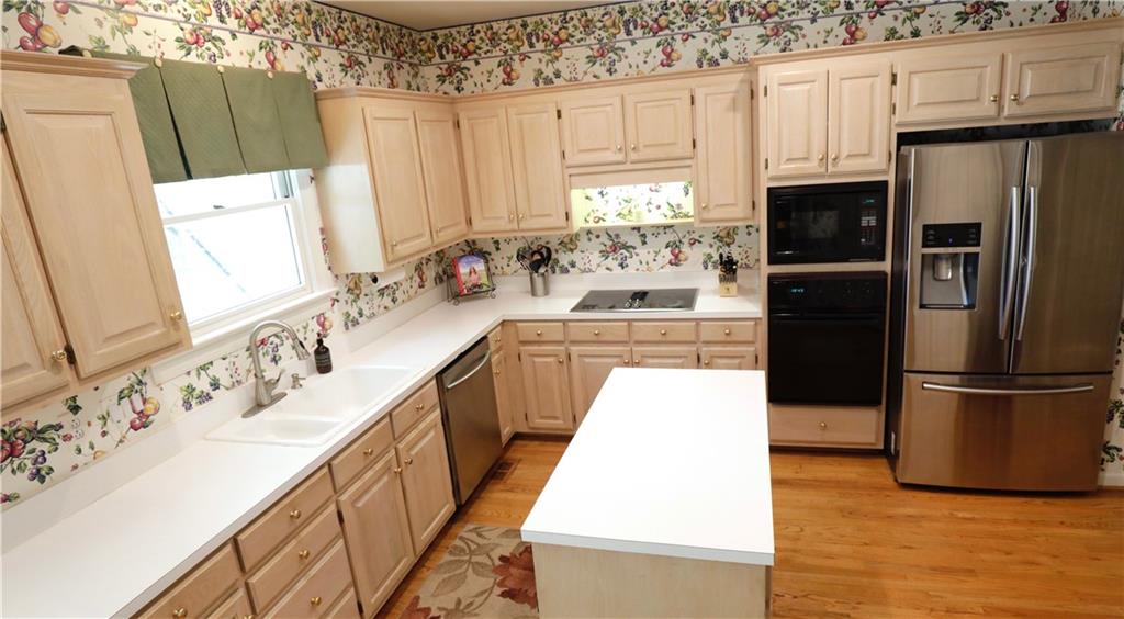 12522 Hawks Ridge Road Huntersville, NC 28078 - Photo 8 of 30 a kitchen with stainless steel appliances a refrigerator sink and cabinets