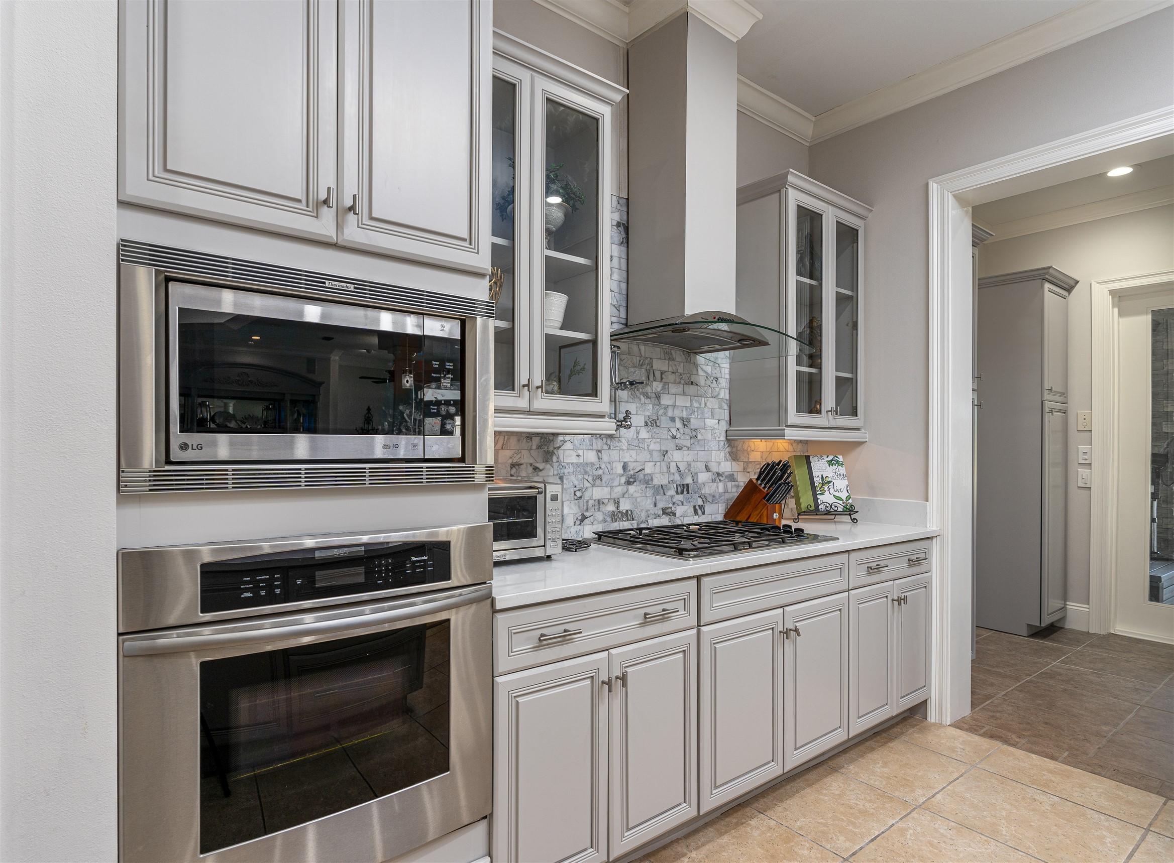 2949 Pine Valley Road Miramar Beach, FL 32550 - Photo 12 of 29 a kitchen with stainless steel appliances granite countertop a stove microwave and cabinets