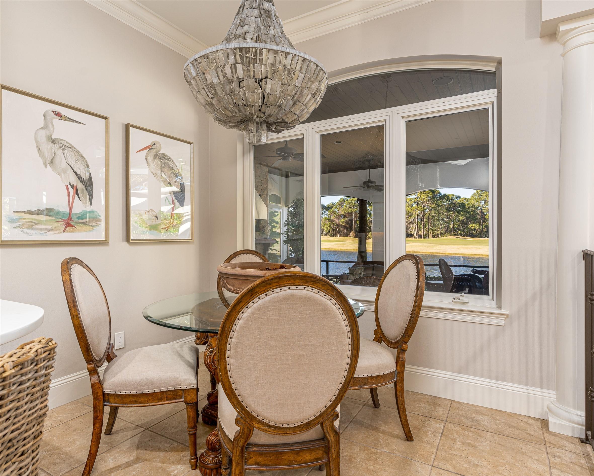 2949 Pine Valley Road Miramar Beach, FL 32550 - Photo 25 of 29 a dining room with furniture a chandelier and wooden floor