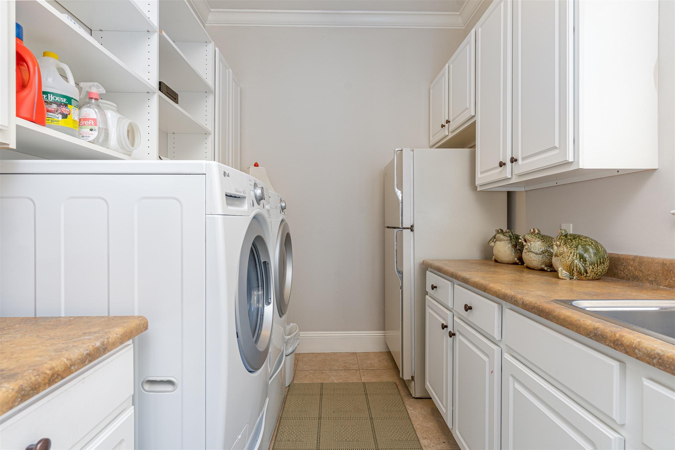 2949 Pine Valley Road Miramar Beach, FL 32550 - Photo 28 of 29 a utility room with cabinets washer and dryer